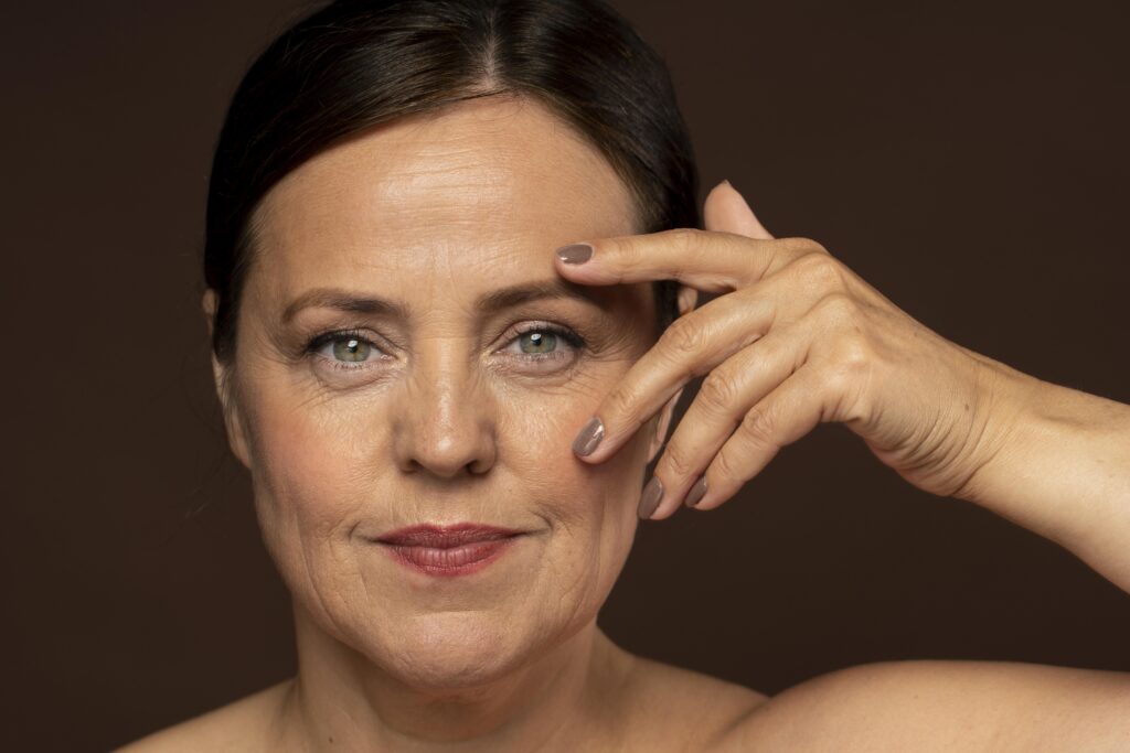 smiley-older-woman-posing-with-make-up-showing-off-nails